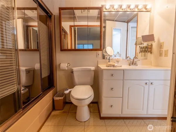a bathroom with a toilet sink and mirror