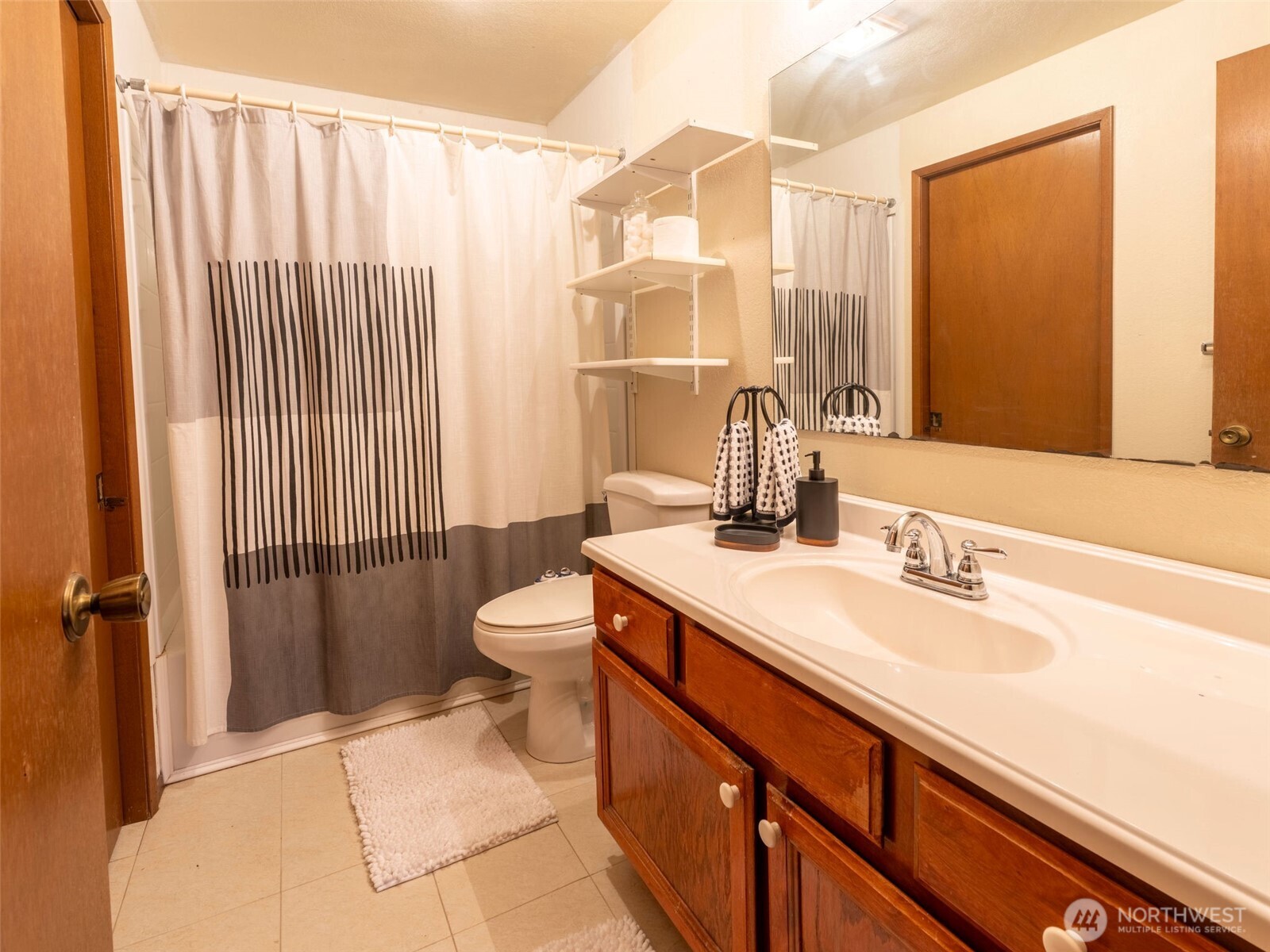 928 North 98th Street Seattle, WA 98103 - Photo 6 of 16 a bathroom with a sink a toilet and shower