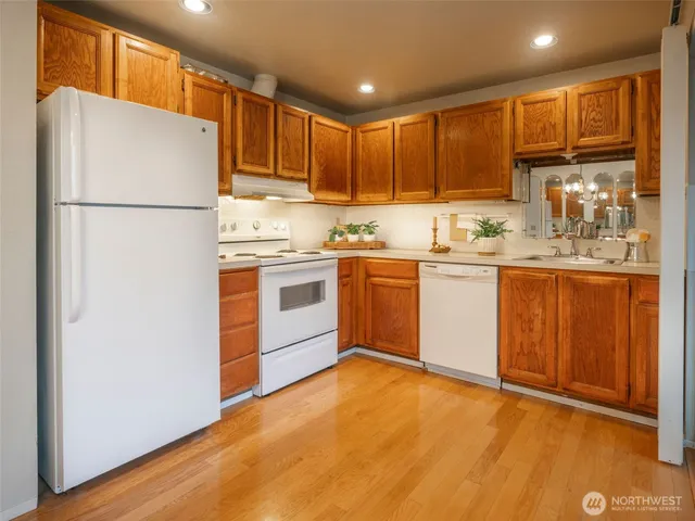 a kitchen with stainless steel appliances granite countertop a refrigerator sink and cabinets