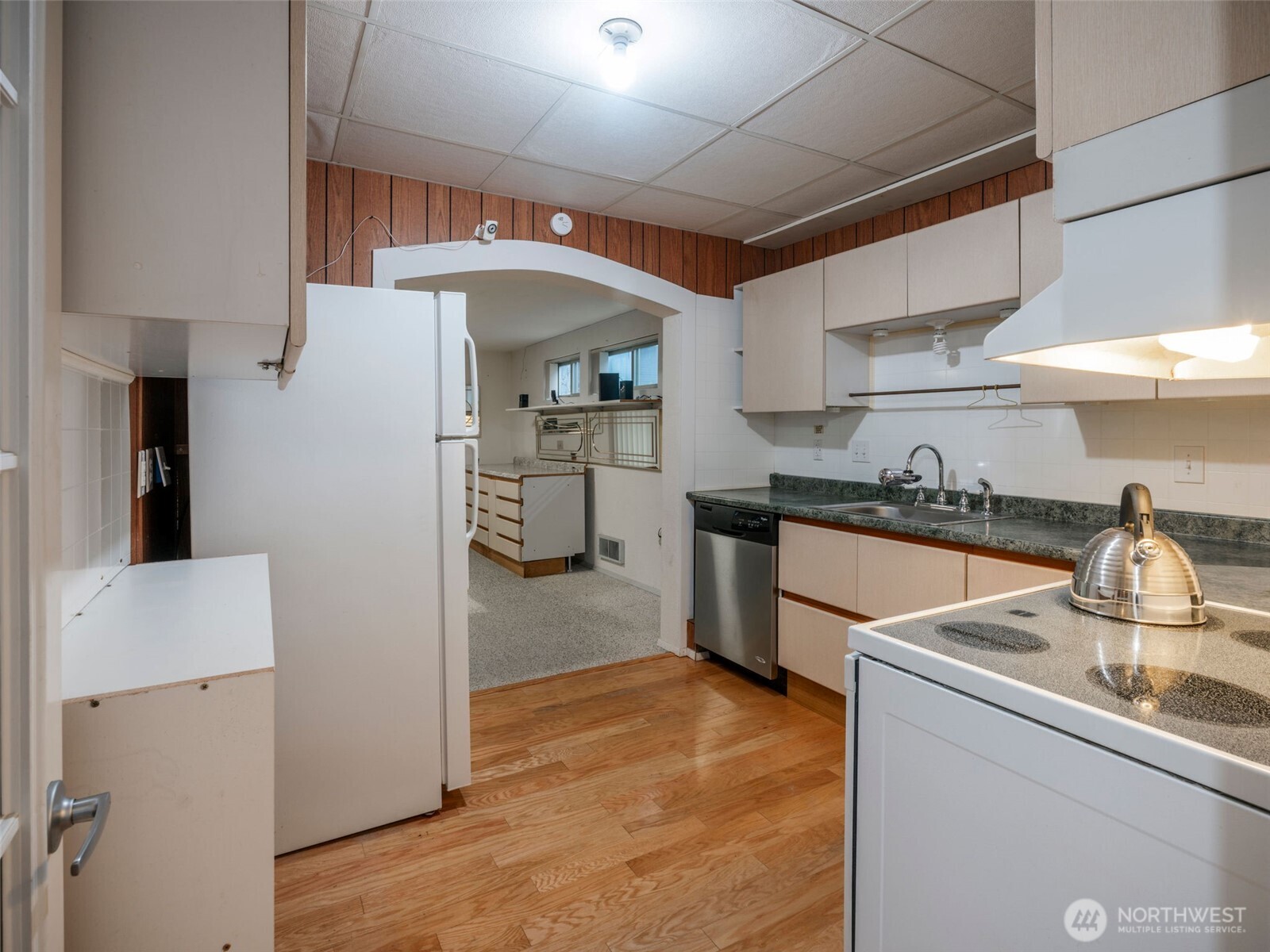 928 North 98th Street Seattle, WA 98103 - Photo 9 of 16 a kitchen with stainless steel appliances a sink stove and refrigerator