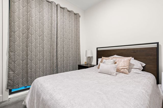 a bedroom with a bed and curtain