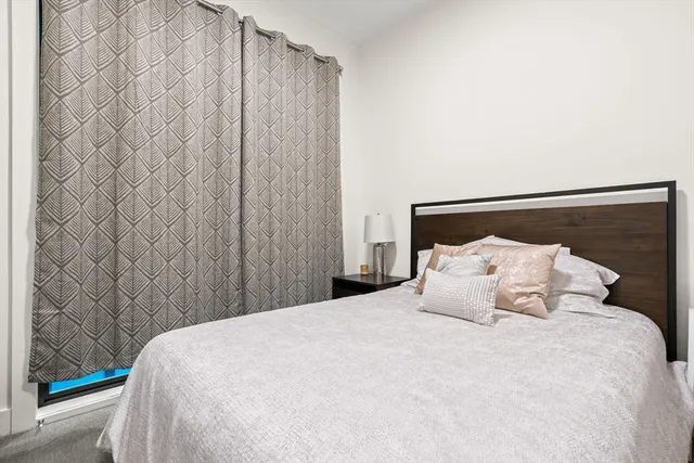 a bedroom with a bed and curtain