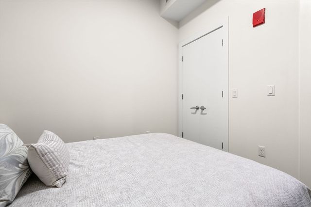 a bedroom with a bed and a closet