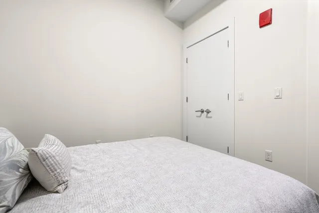 a bedroom with a bed and a closet