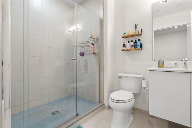 a bathroom with a toilet and a shower