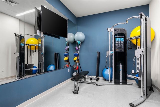 a view of a dining room with furniture a chandelier and wooden floor