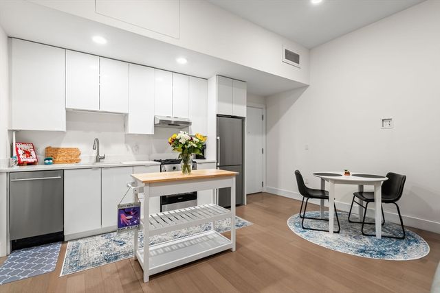 a kitchen with a table chairs and a stove