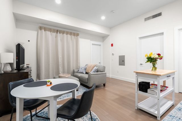 a living room with furniture a chandelier and a table