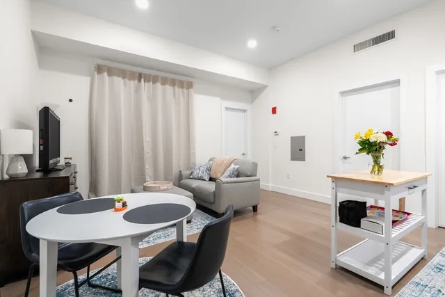 a living room with furniture a chandelier and a table