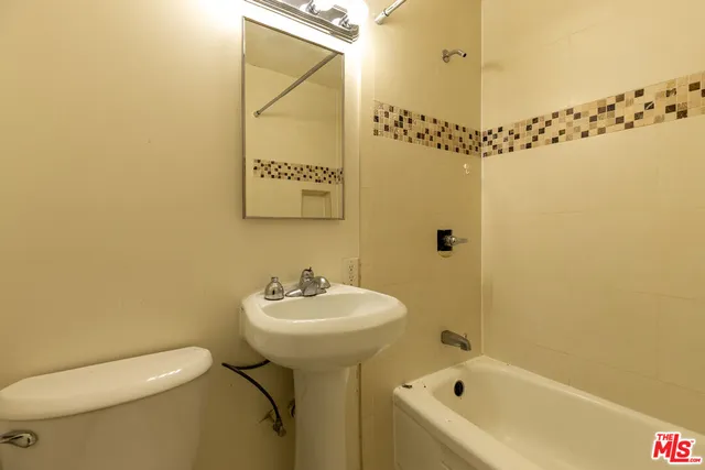 a bathroom with a sink a mirror and a bathtub