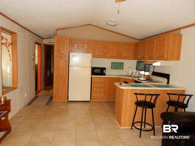 548 Escambia Loop Lillian, AL 36549 - Photo 4 of 16 Kitchen Tile floors in Living room & kitchen
