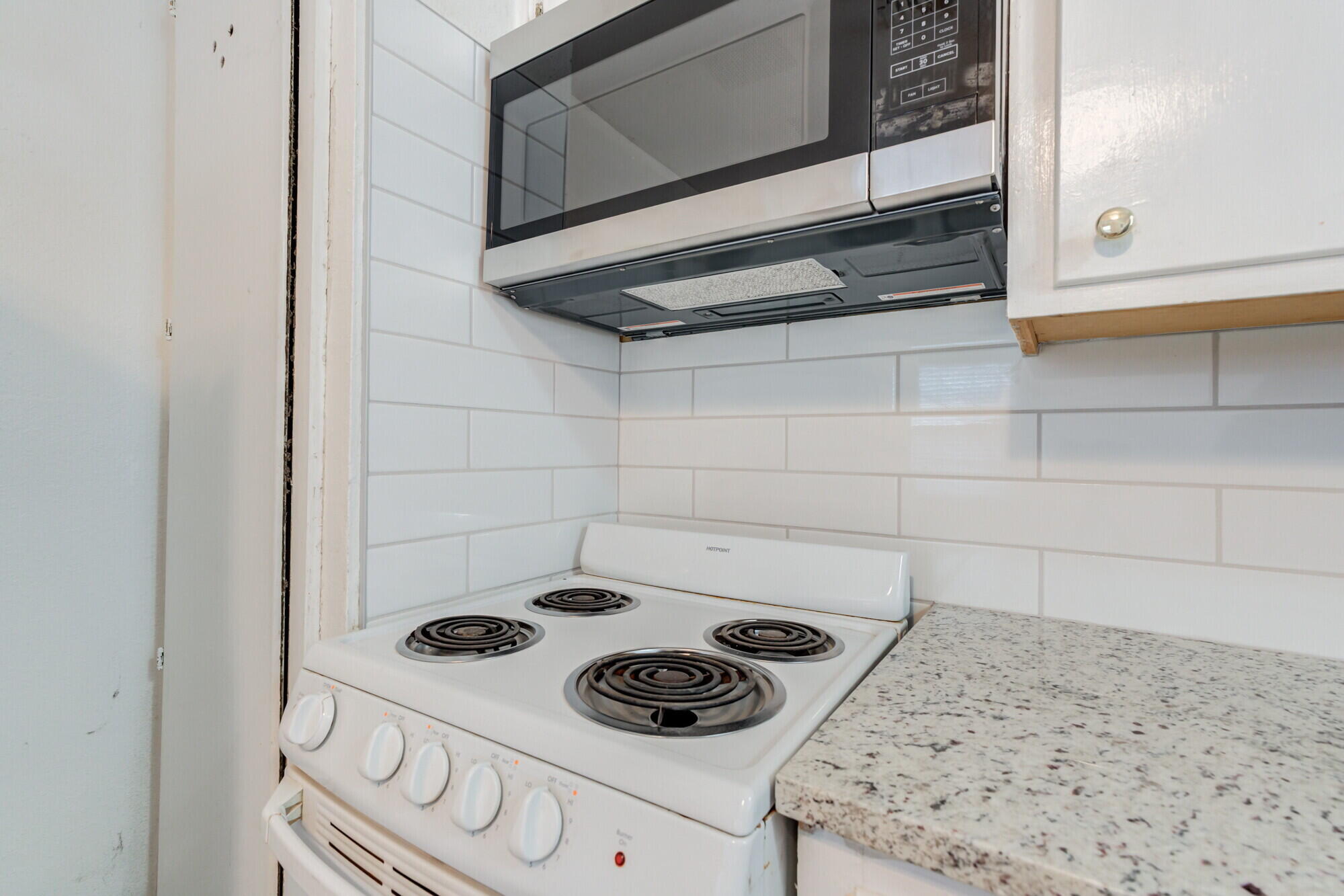 2701 36th Street Lubbock, TX 79413 - Photo 11 of 23 a kitchen with a stove and a microwave