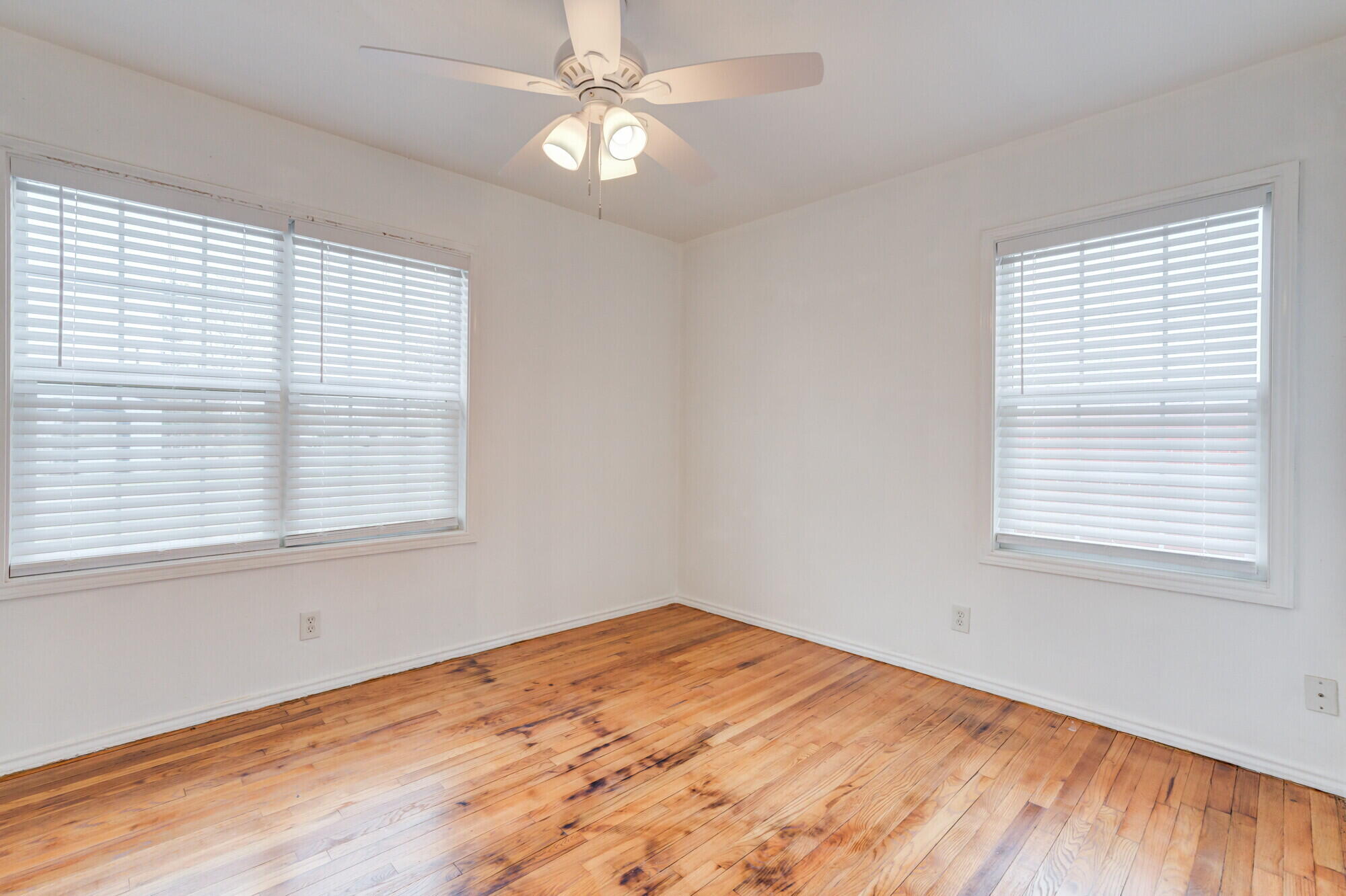 2701 36th Street Lubbock, TX 79413 - Photo 13 of 23 a view of empty room with wooden floor and fan