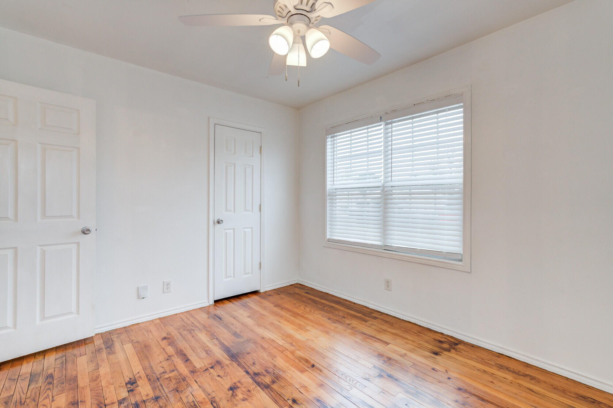 2701 36th Street Lubbock, TX 79413 - Photo 14 of 23 a view of empty room with wooden floor and fan