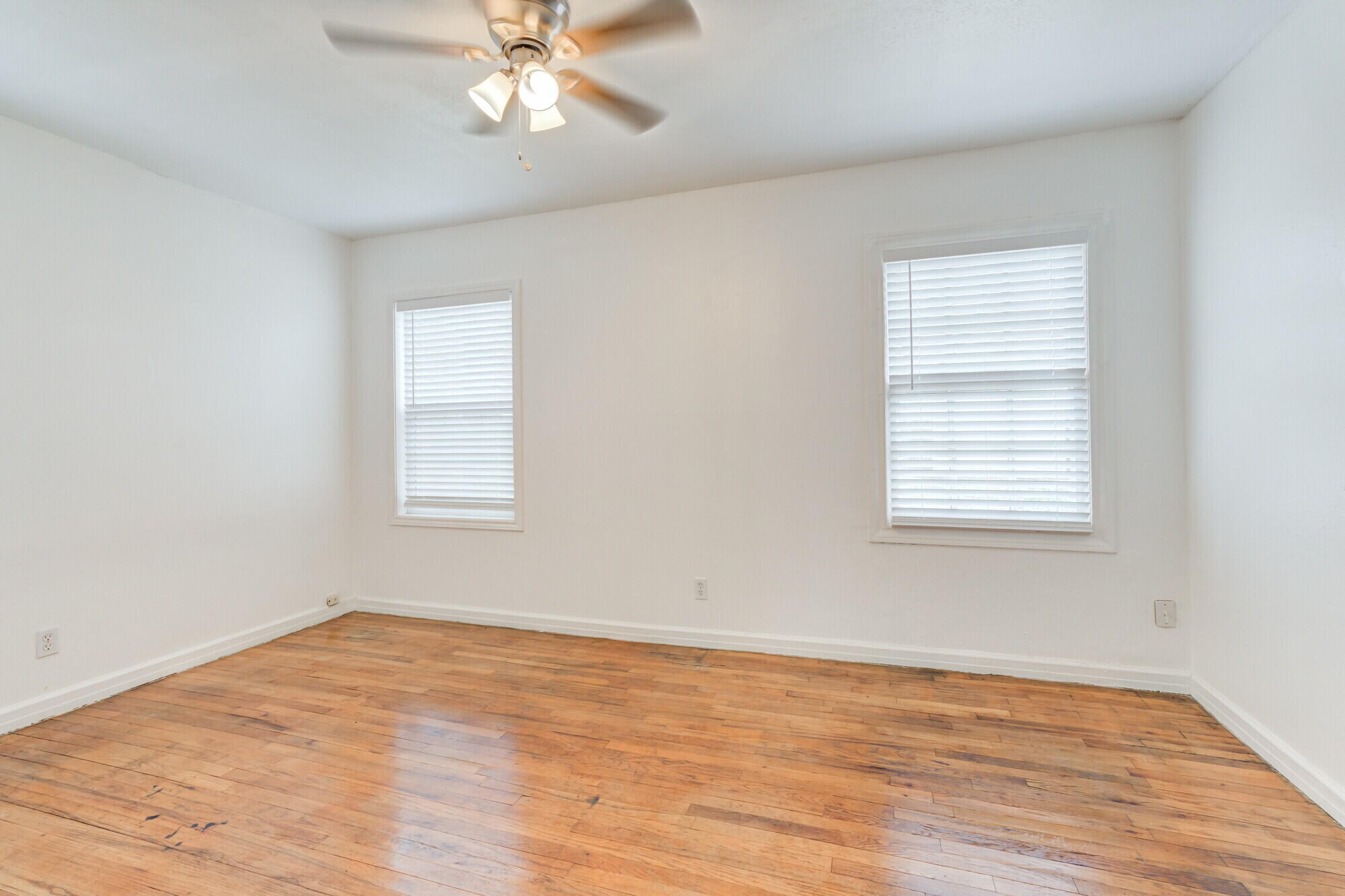 2701 36th Street Lubbock, TX 79413 - Photo 17 of 23 wooden floor in an empty room with a window