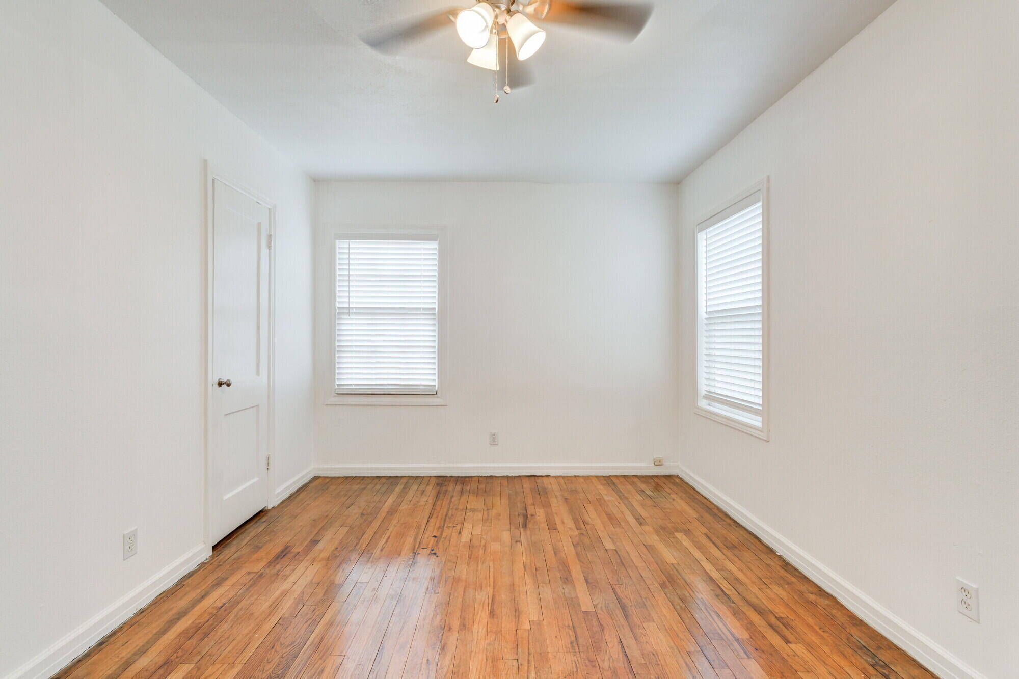2701 36th Street Lubbock, TX 79413 - Photo 18 of 23 wooden floor in an empty room with a window