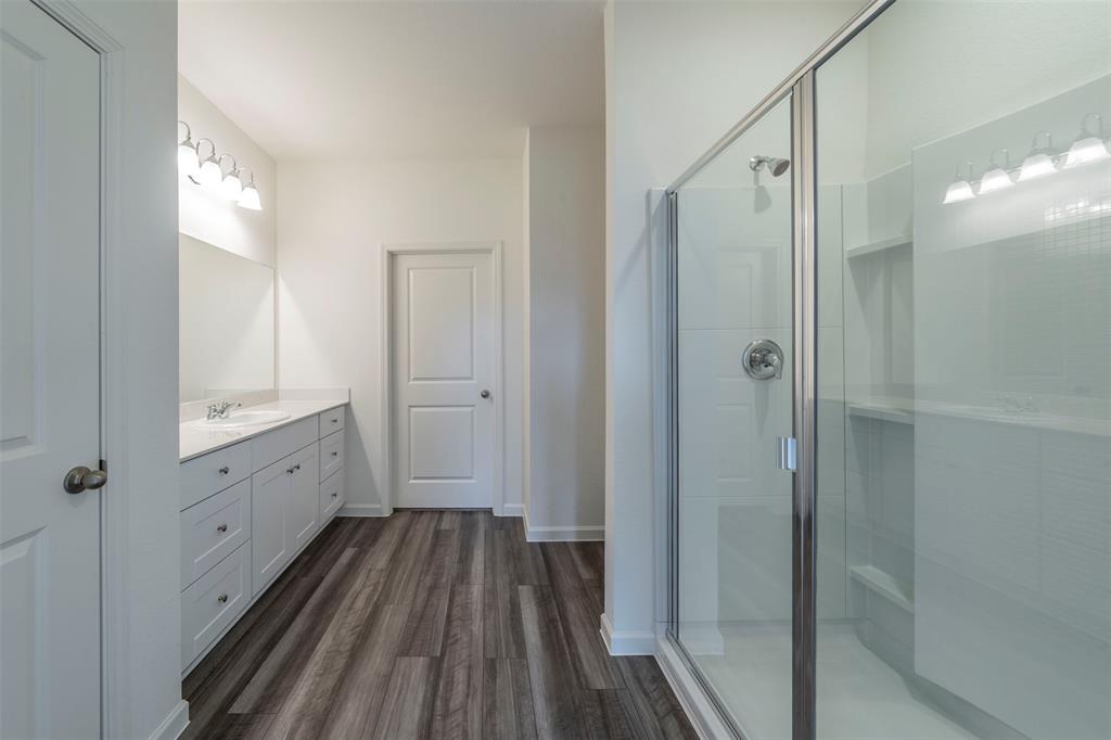 1838 Mccree Street Forney, TX 75126 - Photo 11 of 33 a bathroom with a sink a toilet and shower