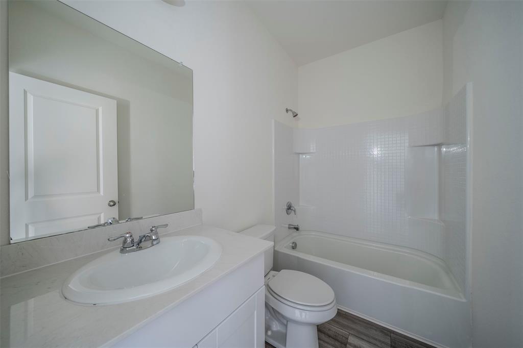 1838 Mccree Street Forney, TX 75126 - Photo 15 of 33 a bathroom with a sink and a bathtub