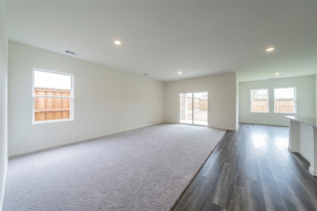 1838 Mccree Street Forney, TX 75126 - Photo 2 of 33 an empty room with wooden floor and windows