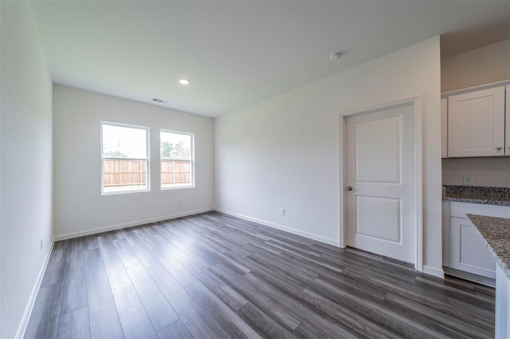 1838 Mccree Street Forney, TX 75126 - Photo 8 of 33 a view of an empty room with a window and wooden floor