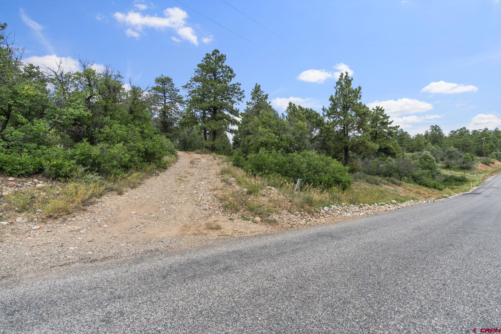 661 Ridge Road Durango, CO 81303 - Photo 15 of 17 a view of a dirt road with a building in the background