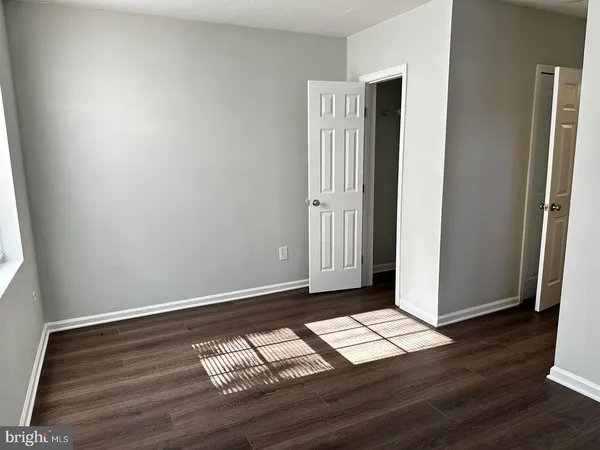 a view of wooden floor with windows in an empty room