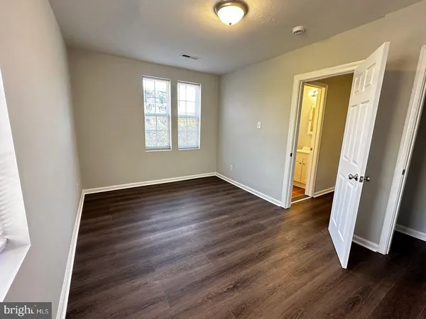 a view of a room with wooden floor and window