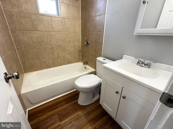 a bathroom with a sink a toilet and a bathtub