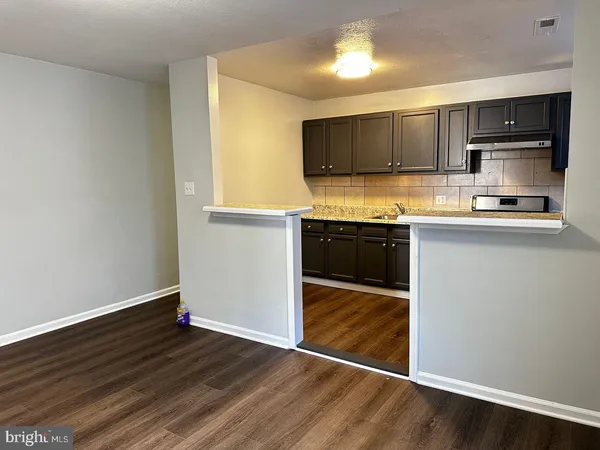a kitchen with stainless steel appliances a sink and microwave
