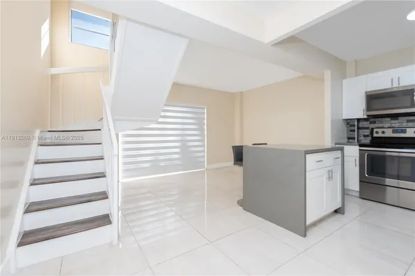 a kitchen with stainless steel appliances and white cabinets