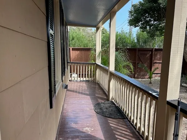 a view of a balcony with wooden floor
