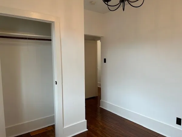 a view of a room with wooden floor