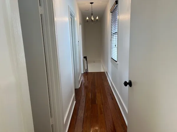 a view of entryway and hall with wooden floor