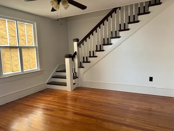 a view of entryway and hall with wooden floor