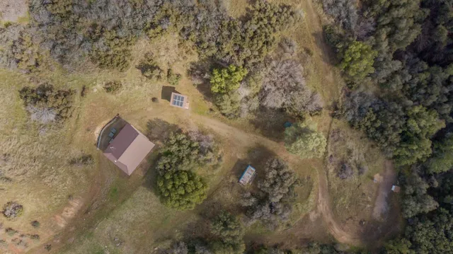 a living room with furniture kitchen view and a chandelier