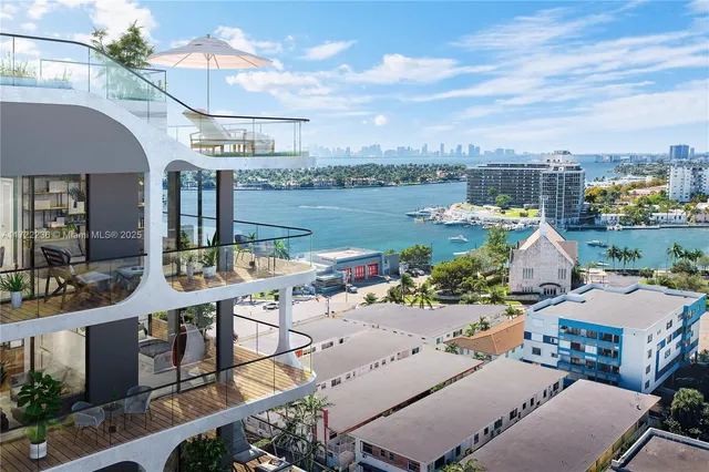 an aerial view of a house with garden space and ocean view
