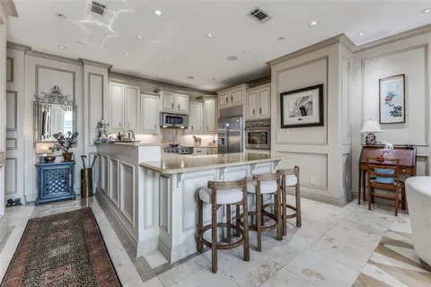 a kitchen with stainless steel appliances granite countertop a sink and dishwasher a stove with white cabinets