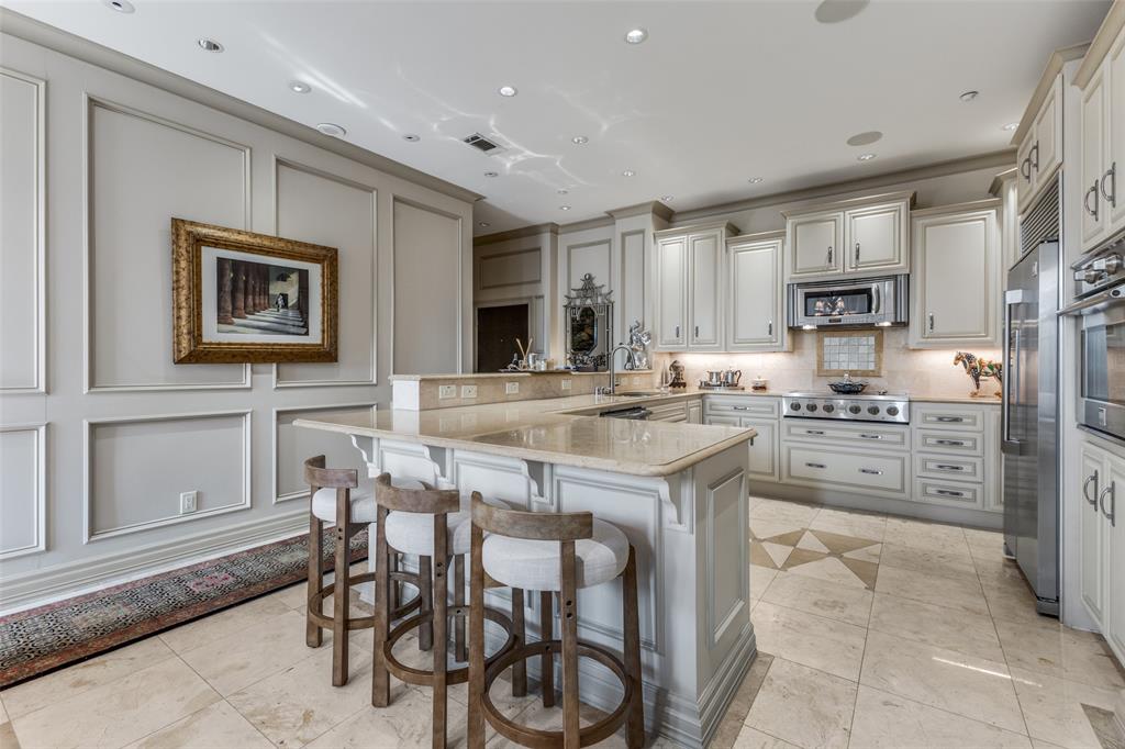5909 Luther Lane, Unit 707 Dallas, TX 75225 - Photo 7 of 14 a kitchen with stainless steel appliances granite countertop a stove and a refrigerator