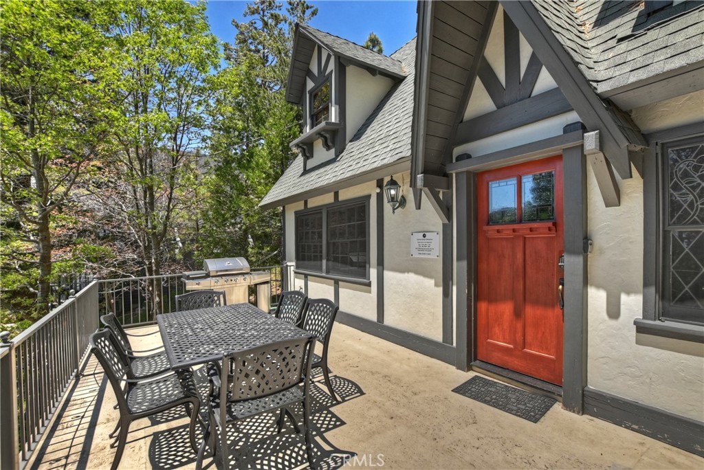 349 Golf Course Road Lake Arrowhead, CA 92352 - Photo 1 of 1 a view of a patio with table and chairs with wooden floor and fence