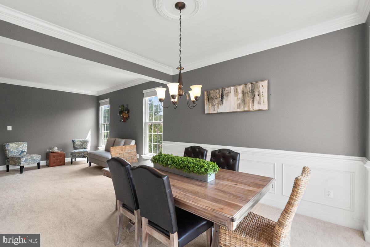 42819 Conquest Circle Ashburn, VA 20148 - Photo 14 of 55 a living room with furniture and a chandelier