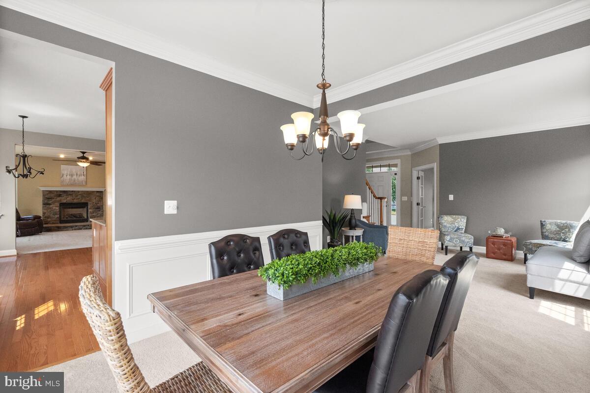 42819 Conquest Circle Ashburn, VA 20148 - Photo 15 of 55 a view of a dining room with furniture and wooden floor