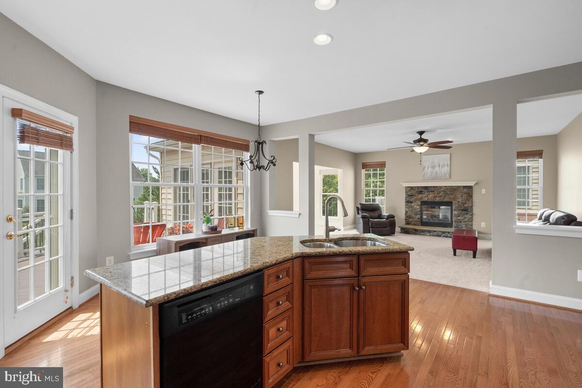 42819 Conquest Circle Ashburn, VA 20148 - Photo 19 of 55 a kitchen with granite countertop a sink and a stove top oven