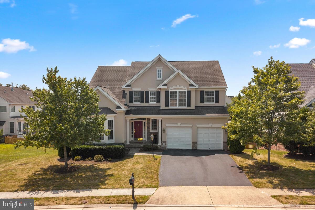 42819 Conquest Circle Ashburn, VA 20148 - Photo 3 of 55 a front view of a house with a yard