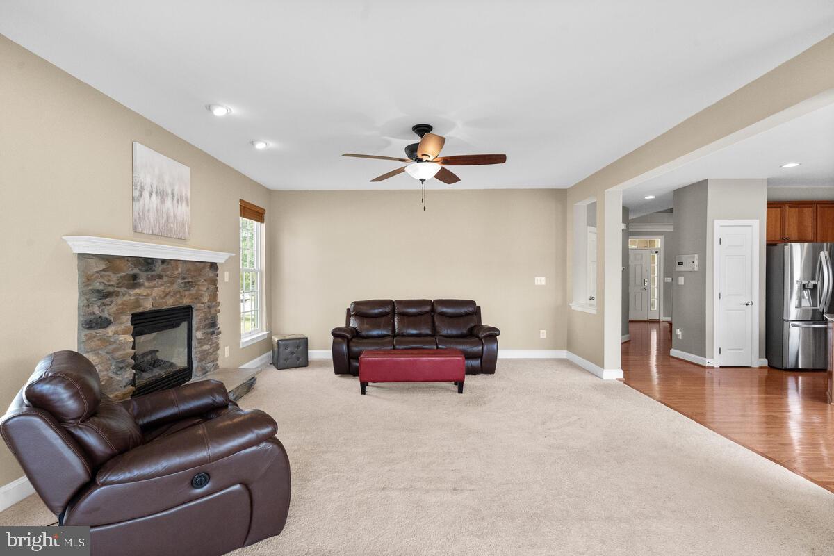 42819 Conquest Circle Ashburn, VA 20148 - Photo 24 of 55 a living room with furniture and a fireplace
