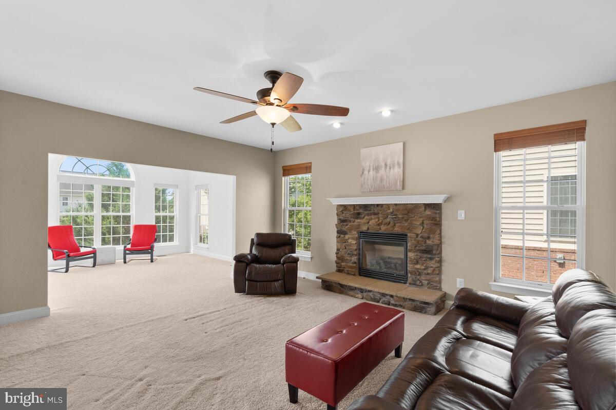 42819 Conquest Circle Ashburn, VA 20148 - Photo 25 of 55 a living room with furniture and a fireplace