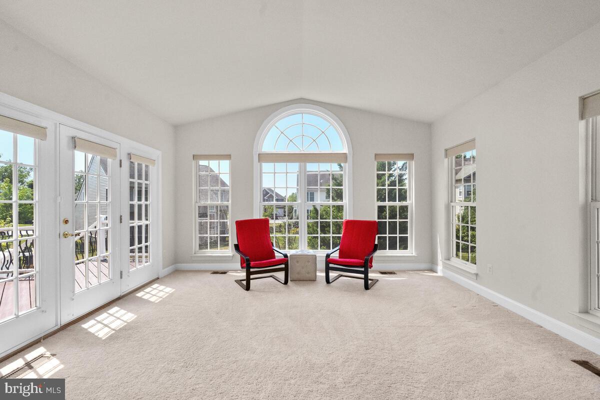 42819 Conquest Circle Ashburn, VA 20148 - Photo 27 of 55 a living room with furniture and floor to ceiling windows