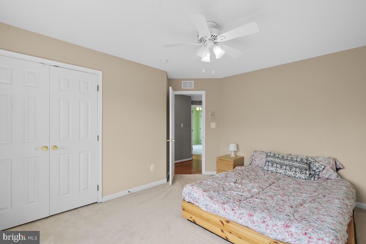42819 Conquest Circle Ashburn, VA 20148 - Photo 35 of 55 a bedroom with a bed and a chandelier
