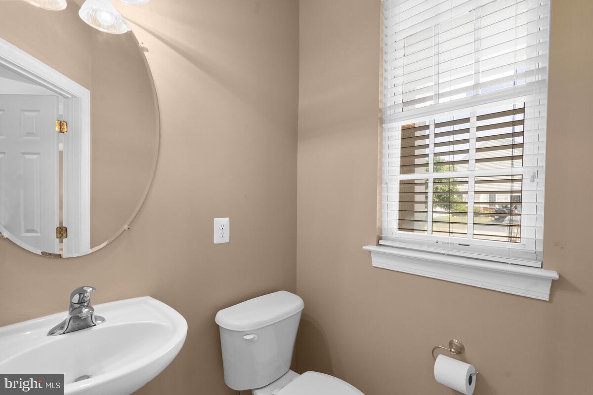 42819 Conquest Circle Ashburn, VA 20148 - Photo 10 of 55 a bathroom with a toilet a sink a mirror and a window