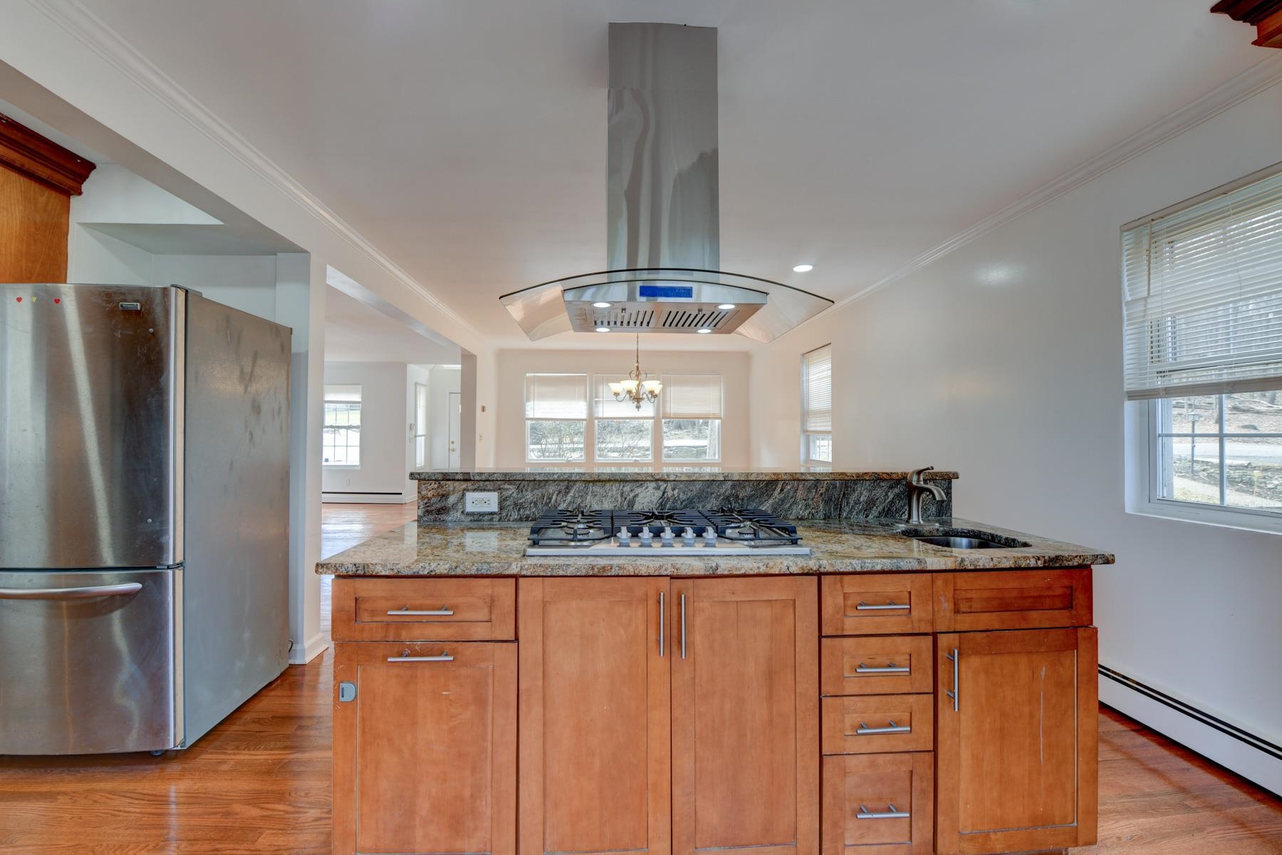 a kitchen with stainless steel appliances granite countertop a refrigerator and a sink