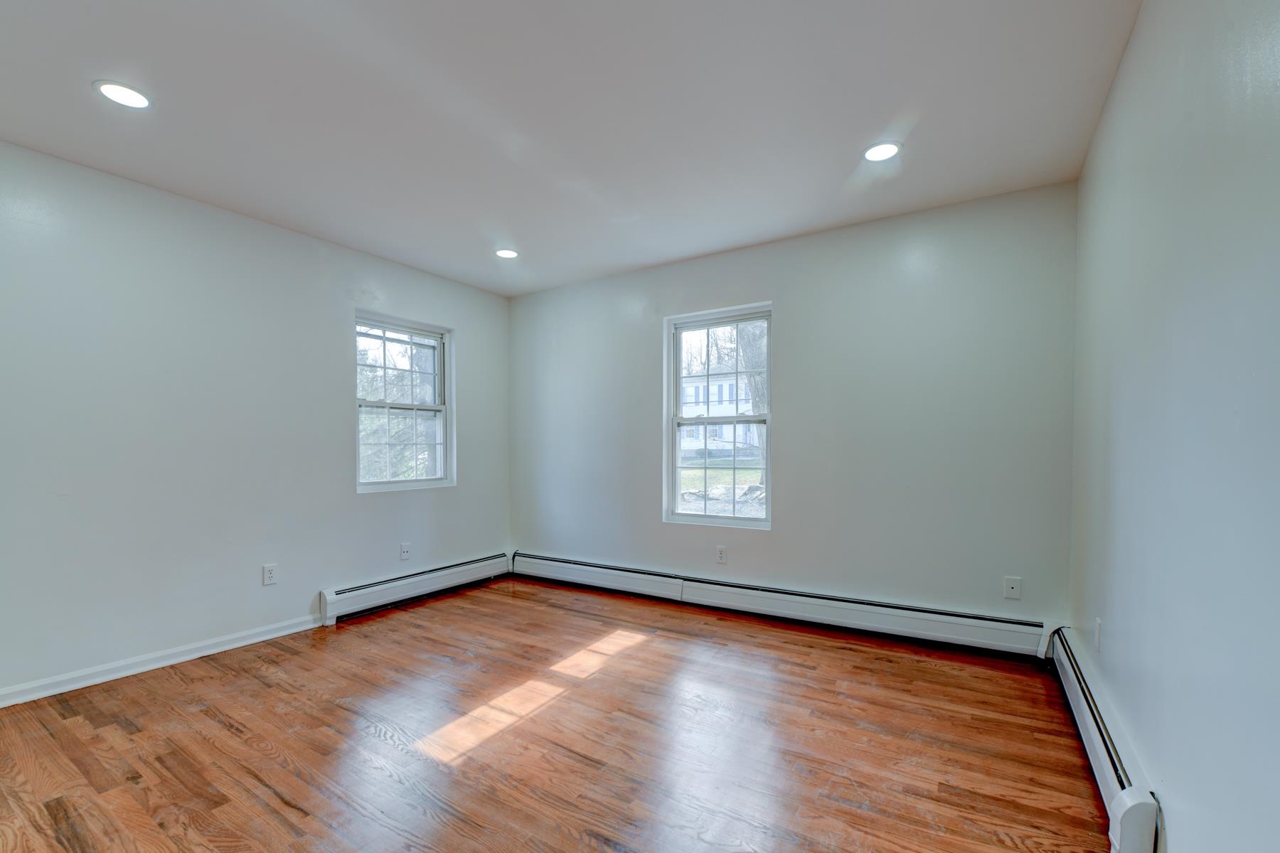 10 Toye Street Randolph, NJ 07869 - Photo 14 of 48 an empty room with wooden floor and windows